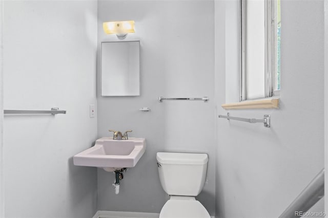 half bath with toilet and a sink