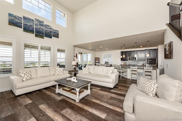 8761 S Wenatchee Ct, Aurora, CO 80016 - living area featuring dark wood-style flooring and a towering ceiling
