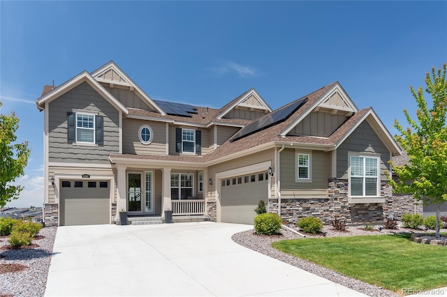 8761 S Wenatchee Ct, Aurora, CO 80016 - craftsman-style home with board and batten siding, stone siding, driveway, solar panels, and a porch