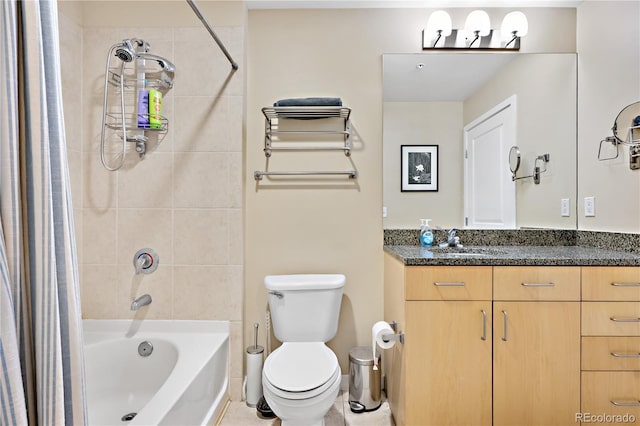 full bathroom featuring tiled shower / bath combo, toilet, and vanity