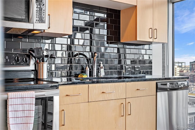 kitchen with light brown cabinets, backsplash, and stainless steel appliances