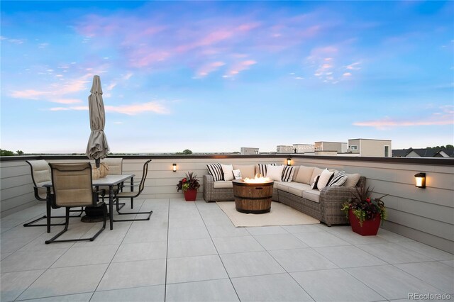 12261 Farmview St, Thornton, CO 80241 - patio terrace at dusk with an outdoor living space with a fire pit and a patio