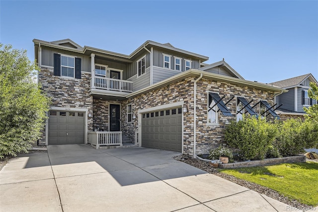 26591 E Calhoun Pl, Aurora, CO 80016 - view of front of property featuring a balcony, stone siding, board and batten siding, driveway, and a garage