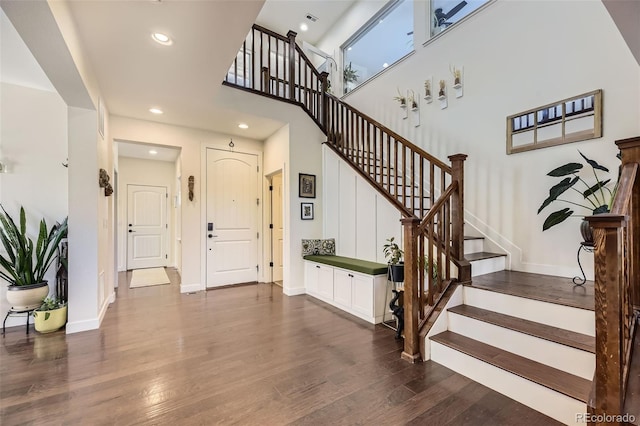 26591 E Calhoun Pl, Aurora, CO 80016 - staircase featuring wood finished floors, a high ceiling, and recessed lighting