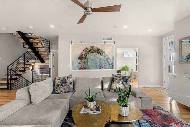 living room with ceiling fan and light hardwood / wood-style floors