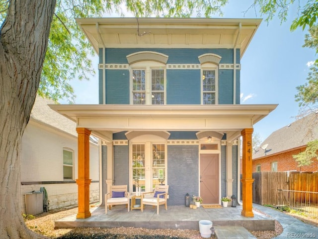 541 Fox St, Denver, CO 80204 - italianate home featuring covered porch and brick siding