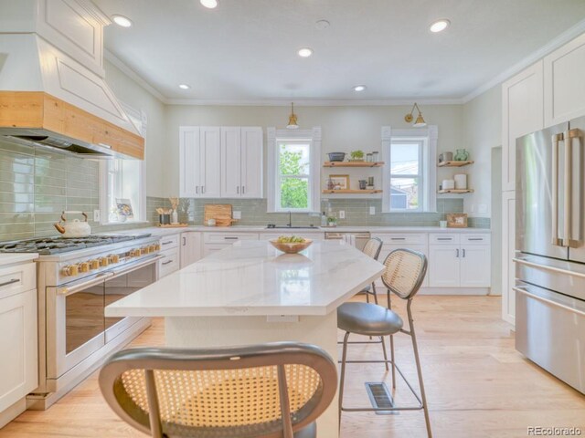 541 Fox St, Denver, CO 80204 - kitchen with double oven range, freestanding refrigerator, open shelves, a breakfast bar, and tasteful backsplash