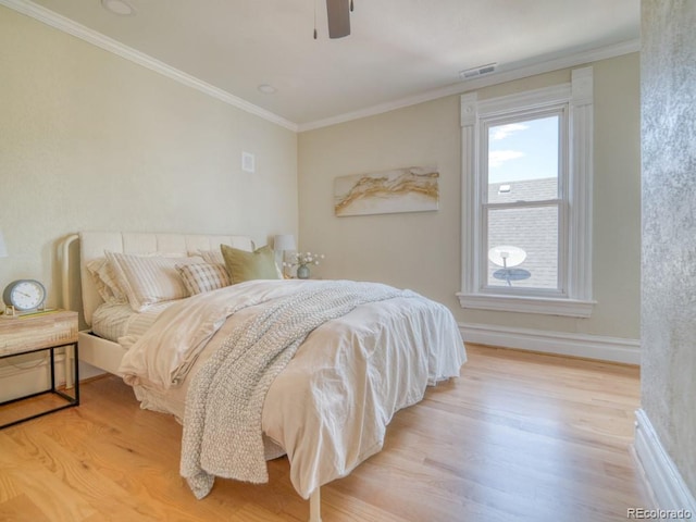 541 Fox St, Denver, CO 80204 - bedroom with wood finished floors, crown molding, and a ceiling fan