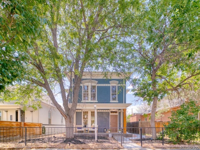 541 Fox St, Denver, CO 80204 - italianate house with a fenced front yard, a gate, and a porch
