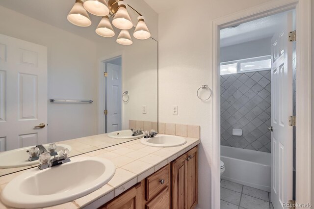 11729 Elmer Linn Dr, Longmont, CO 80504 - full bath with double vanity, a chandelier, tile patterned flooring, and shower / tub combination