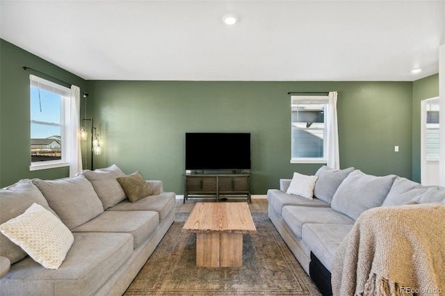 living room featuring dark wood-style flooring, recessed lighting, and baseboards