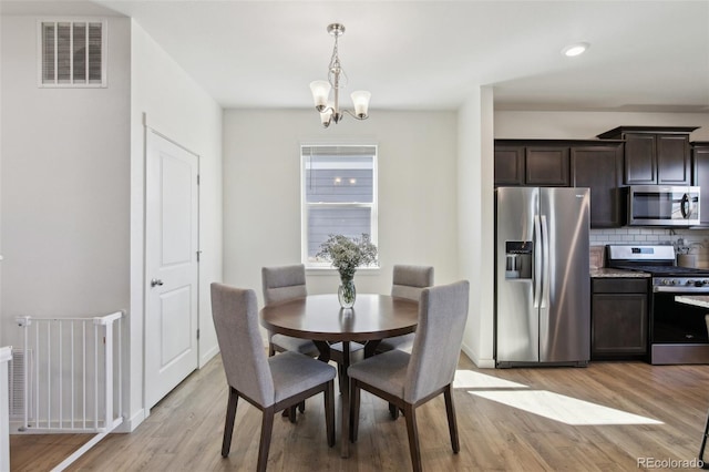 dining area with recessed lighting, visible vents, a chandelier, light wood-type flooring, and baseboards