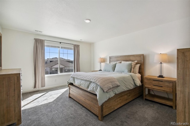 bedroom with carpet floors, visible vents, and baseboards