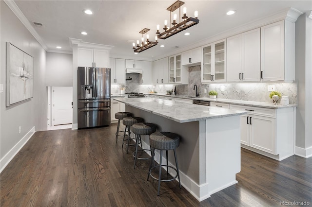 420 N Colorado Blvd, Denver, CO 80206 - kitchen with appliances with stainless steel finishes, a sink, a kitchen island, crown molding, and white cabinets