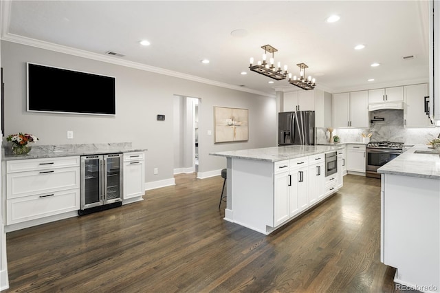 420 N Colorado Blvd, Denver, CO 80206 - kitchen with wine cooler, appliances with stainless steel finishes, ornamental molding, backsplash, and recessed lighting