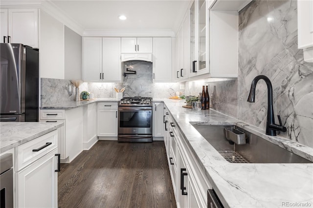 420 N Colorado Blvd, Denver, CO 80206 - kitchen featuring appliances with stainless steel finishes, a sink, light stone counters, white cabinetry, and recessed lighting