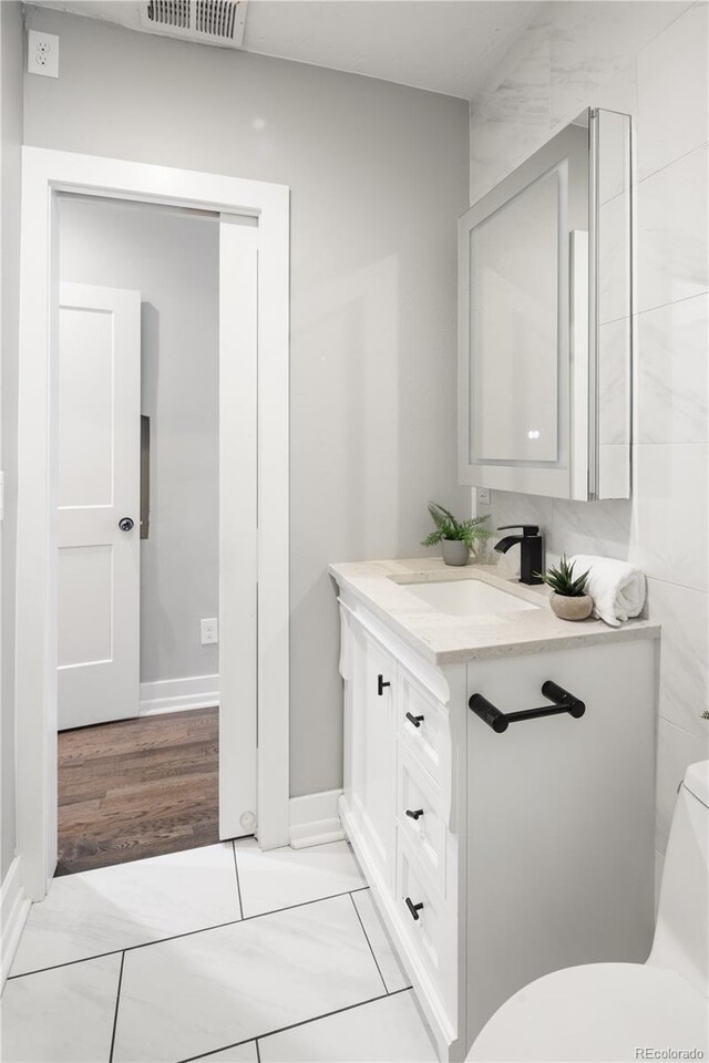 420 N Colorado Blvd, Denver, CO 80206 - bathroom with vanity, toilet, and baseboards