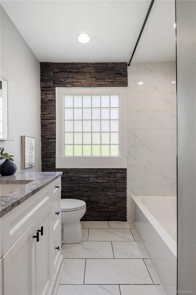 420 N Colorado Blvd, Denver, CO 80206 - full bathroom with vanity, toilet, tub / shower combination, and marble look tiles
