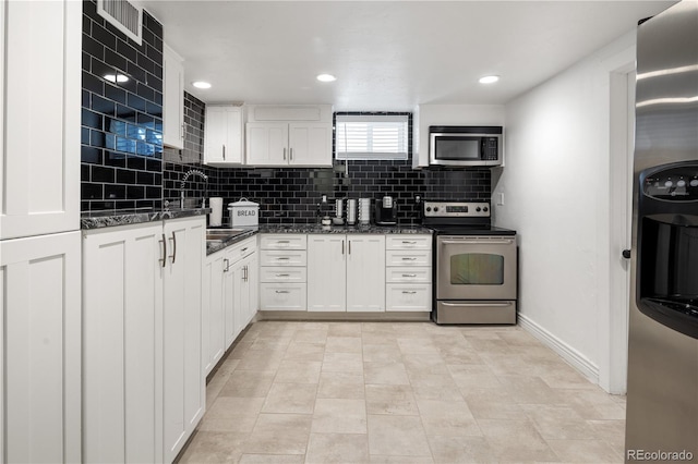 420 N Colorado Blvd, Denver, CO 80206 - kitchen with stainless steel appliances, white cabinets, decorative backsplash, and recessed lighting