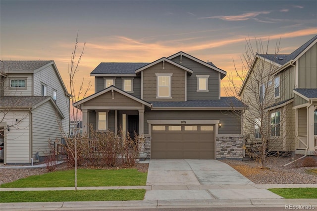 craftsman inspired home with a yard and a garage