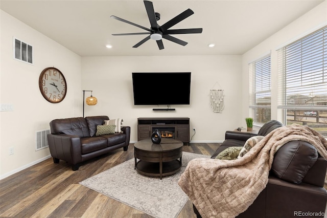 living room featuring dark hardwood / wood-style flooring and ceiling fan