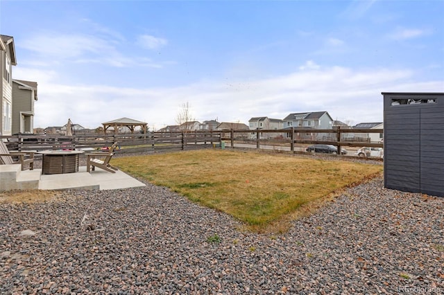 view of yard with a gazebo, a patio area, and an outdoor fire pit