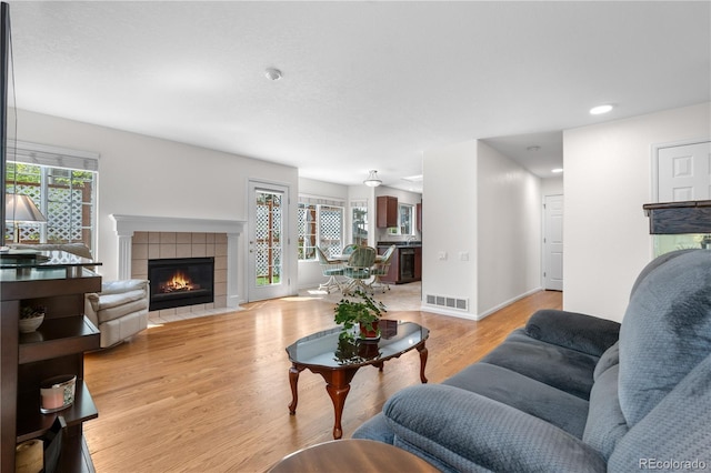 3102 White Oak Trl, Highlands Ranch, CO 80129 - living area featuring a fireplace, light wood-style flooring, recessed lighting, and baseboards
