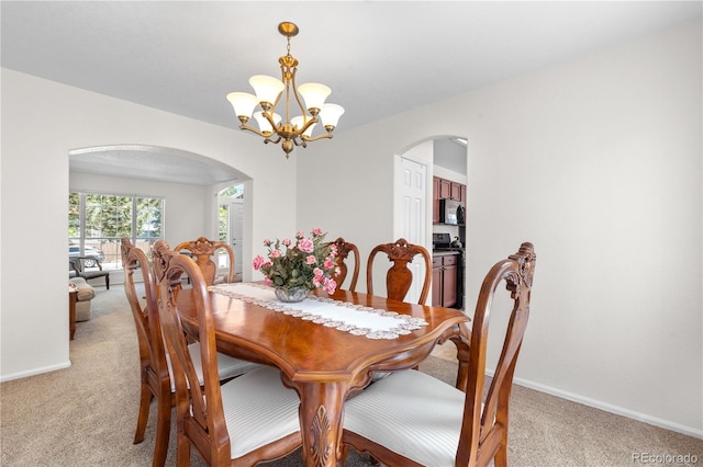 3102 White Oak Trl, Highlands Ranch, CO 80129 - dining space featuring arched walkways, light carpet, a chandelier, and baseboards