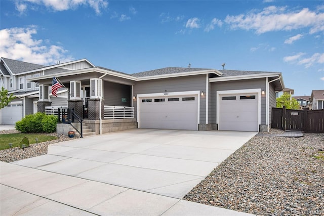 3022 Merlin Dr, Brighton, CO 80601 - view of front facade featuring an attached garage, driveway, a porch, and fence