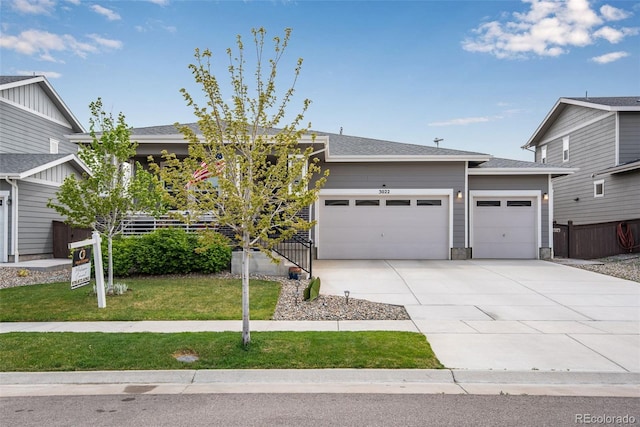 3022 Merlin Dr, Brighton, CO 80601 - view of front facade with a garage, concrete driveway, and a shingled roof