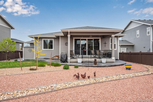 3022 Merlin Dr, Brighton, CO 80601 - back of property featuring fence, roof with shingles, and a patio area