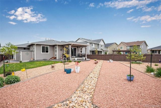 3022 Merlin Dr, Brighton, CO 80601 - view of front of home with a patio area, a fenced backyard, and a residential view