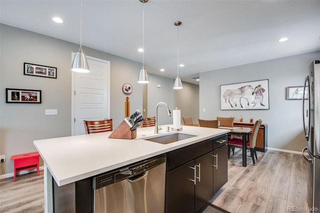 3022 Merlin Dr, Brighton, CO 80601 - kitchen with appliances with stainless steel finishes, a sink, light countertops, light wood-type flooring, and recessed lighting