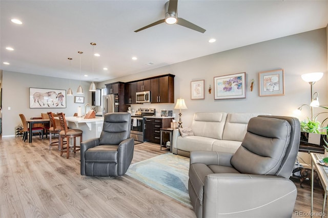 3022 Merlin Dr, Brighton, CO 80601 - living room featuring light wood finished floors, a ceiling fan, and recessed lighting
