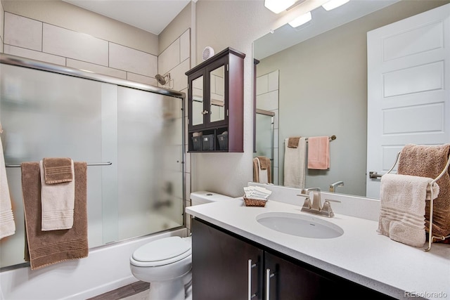3022 Merlin Dr, Brighton, CO 80601 - bathroom with toilet, vanity, and combined bath / shower with glass door