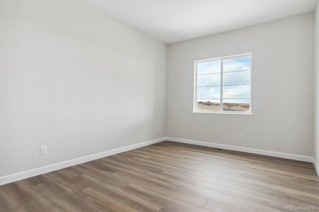 spare room with light wood-type flooring