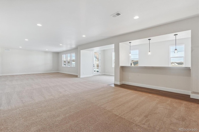 unfurnished room with light colored carpet