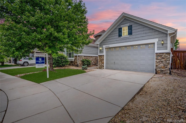 15502 E Flower Mound Pl, Parker, CO 80134 - view of front of property with stone siding, concrete driveway, and a garage
