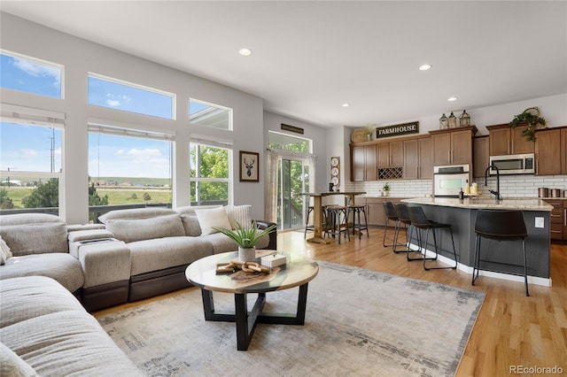 15502 E Flower Mound Pl, Parker, CO 80134 - living area featuring light wood finished floors and recessed lighting