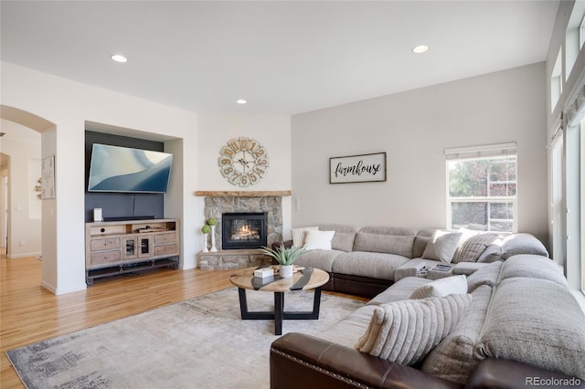 15502 E Flower Mound Pl, Parker, CO 80134 - living area featuring arched walkways, wood finished floors, recessed lighting, and a fireplace