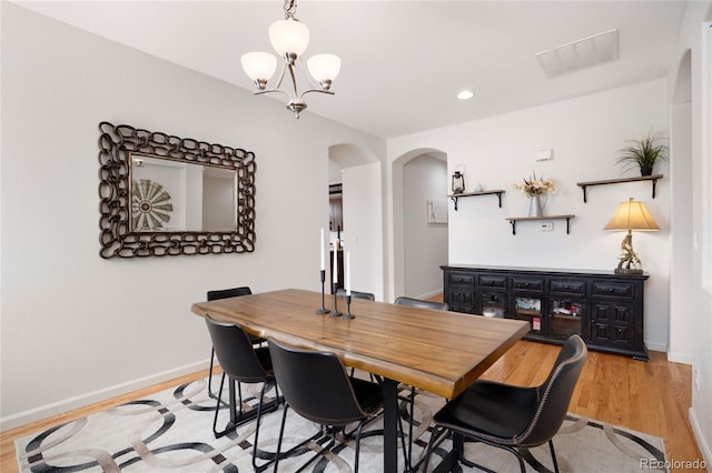15502 E Flower Mound Pl, Parker, CO 80134 - dining space featuring arched walkways, a chandelier, light wood finished floors, and recessed lighting