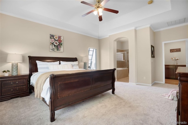 15502 E Flower Mound Pl, Parker, CO 80134 - bedroom with arched walkways, carpet, a tray ceiling, crown molding, and ensuite bathroom