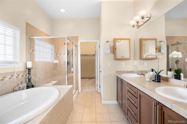 15502 E Flower Mound Pl, Parker, CO 80134 - full bathroom featuring a stall shower, double vanity, a bath, and tile patterned flooring