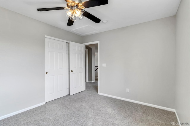 1526 Braewood Ave, Littleton, CO 80129 - unfurnished bedroom with carpet floors, baseboards, attic access, a closet, and a ceiling fan