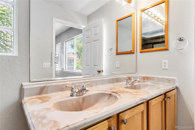 1526 Braewood Ave, Littleton, CO 80129 - full bathroom with double vanity and a textured wall