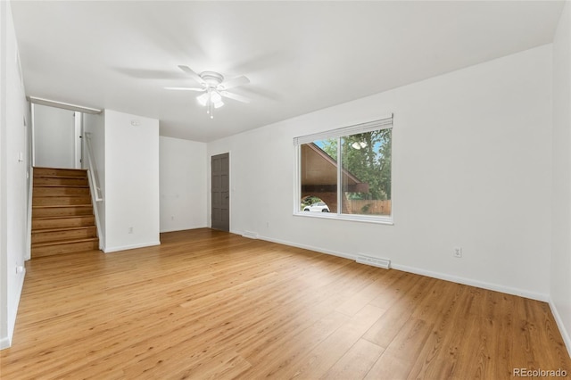 4617 S Norfolk Way, Aurora, CO 80015 - spare room with ceiling fan, light wood-type flooring, and stairway