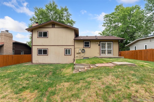 4617 S Norfolk Way, Aurora, CO 80015 - back of house with a fenced backyard and a chimney
