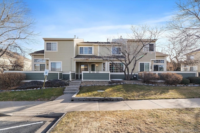 view of front property featuring covered porch and a front lawn