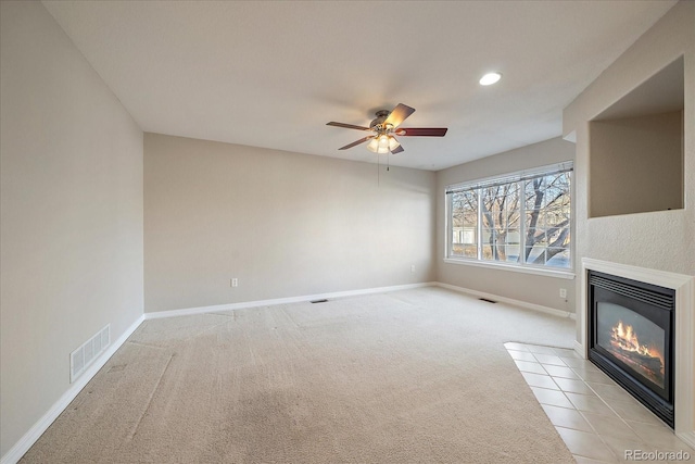 unfurnished living room with light carpet and ceiling fan