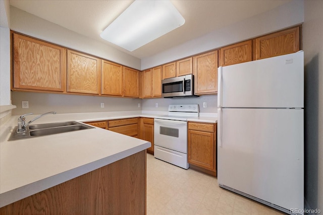 kitchen featuring white appliances and sink